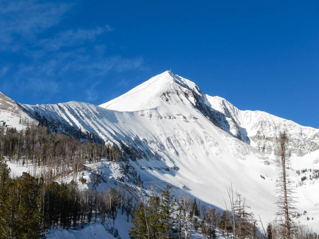 Montana Ski Resorts: Snow covered mountains in the day light and the trees giving an eye catching effect