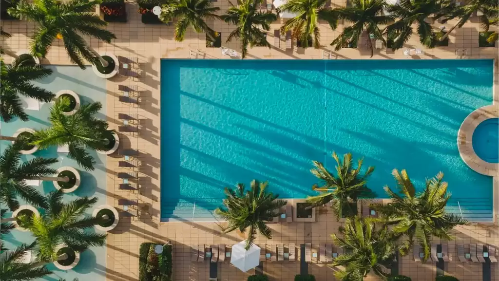 The outside view of Four Season hotel of Maimi in front of sea and trees