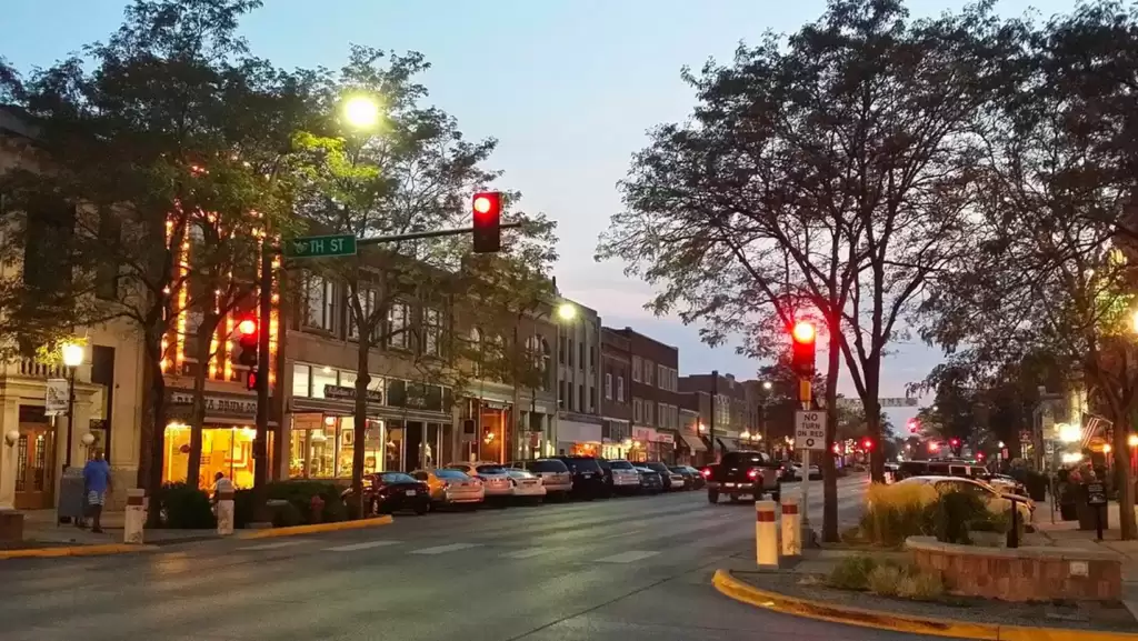 A towering red traffic light majestically positioned in the bustling center of Rapid City.