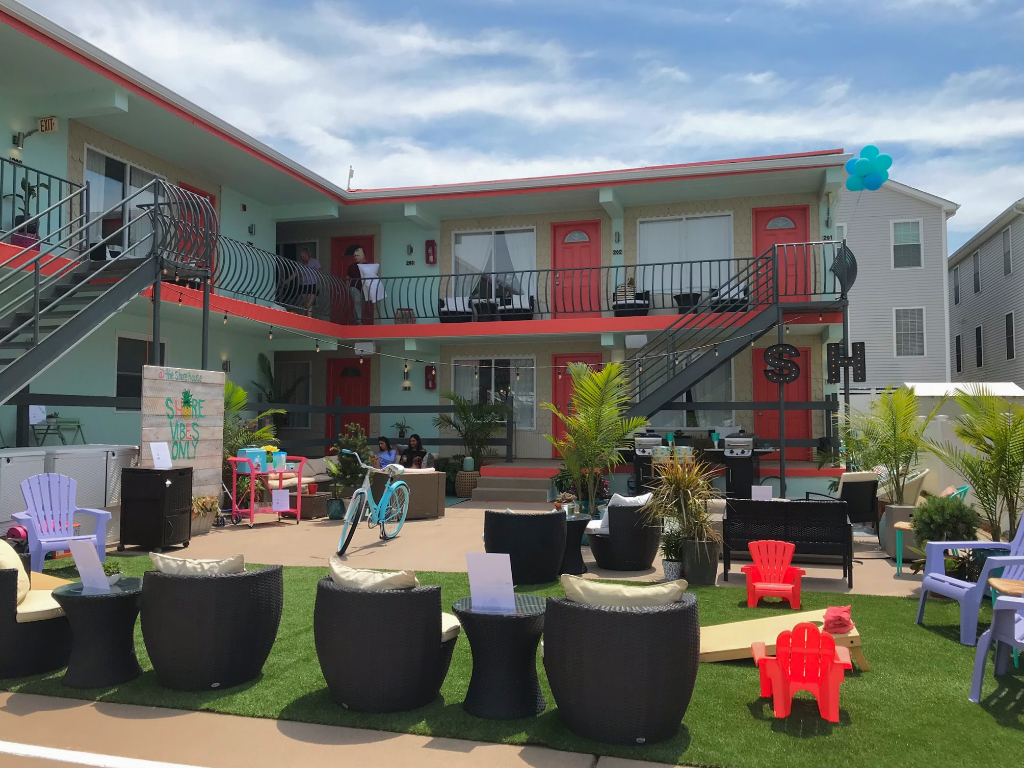 The Shore House Motel is a very beautiful place of hotel looking beautiful under the blue sky, grass and plants