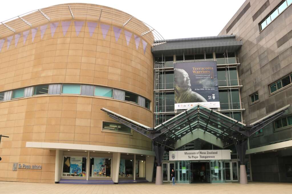 a large building with a sign on the front of it. Visit Te Papa is one of the best things to do in Wellington