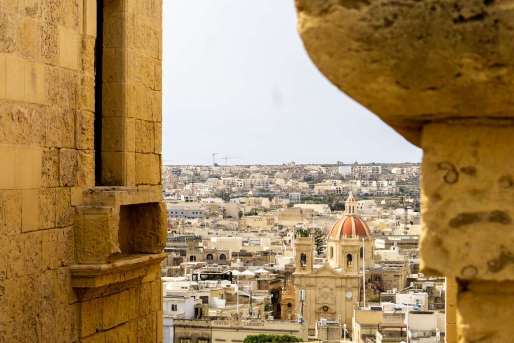 We are exploring the best time to visit Morocco. a view of a city from a window in a building