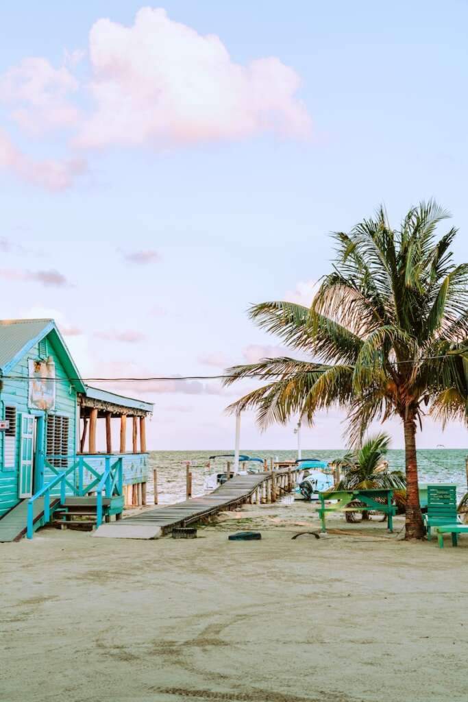 blue wooden house near body of water during daytime looks amazing. If you are searching for where to stay in Belize. You should must visit Caye Caulker