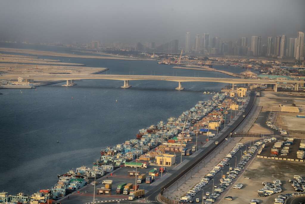 vehicle on road near bridge at daytime looks beautiful, if you are looking for where to stay in Dubai then Deira is amazing to stay