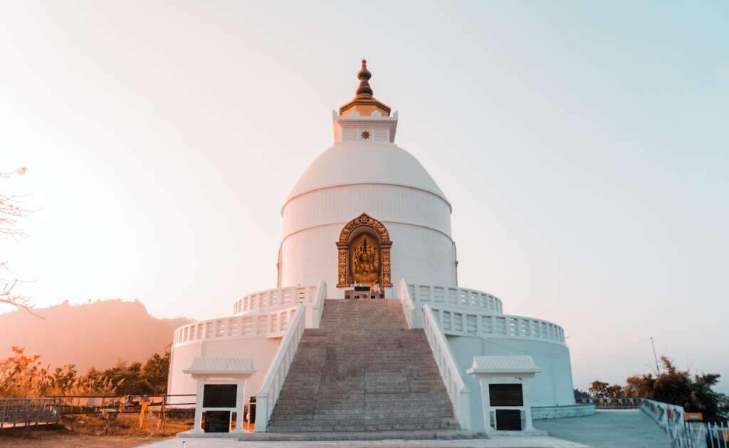 white and gray concrete structure of the World Peace Pagoda. It is one of the amazing things to do in Pokhara