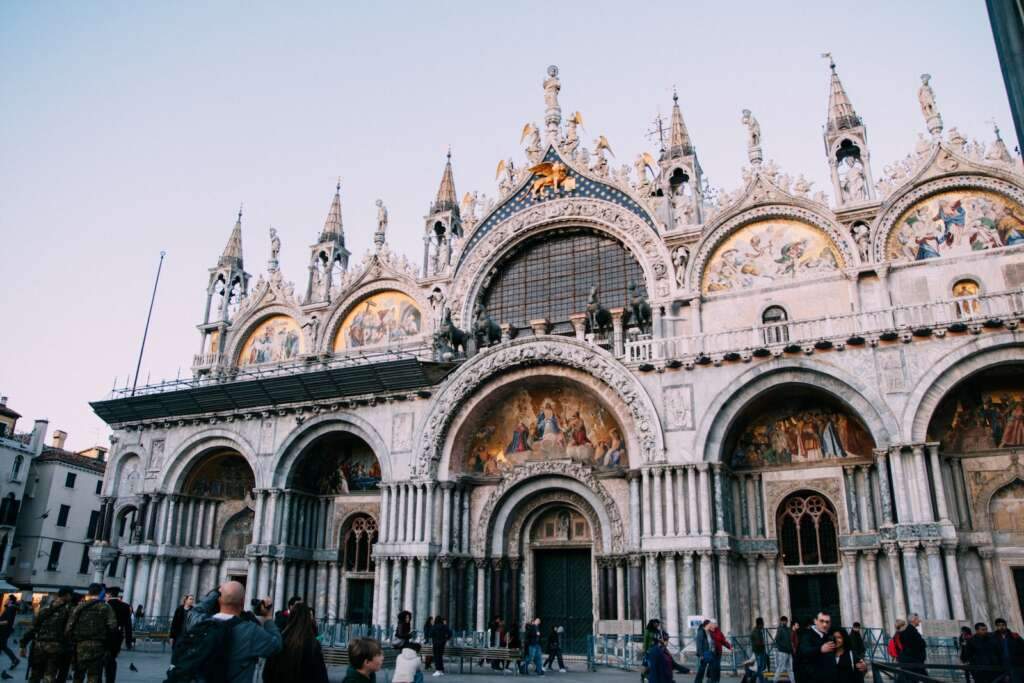 people walking near concrete building during daytime. People who are looking for where to stay in Venice with family then San Polo is the best plce to visit.